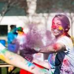 HOLI 2016 female student throwing purple color dust